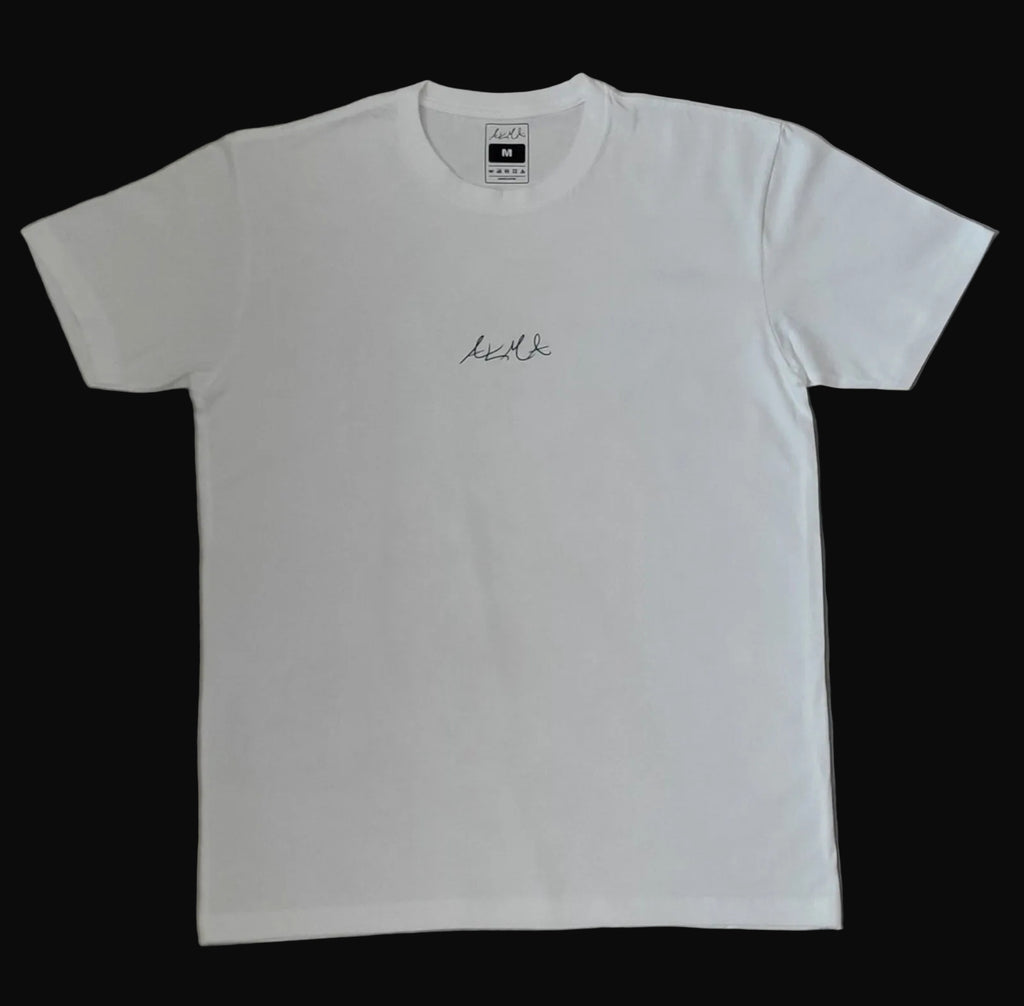 White t-shirt with black text on a beige surface